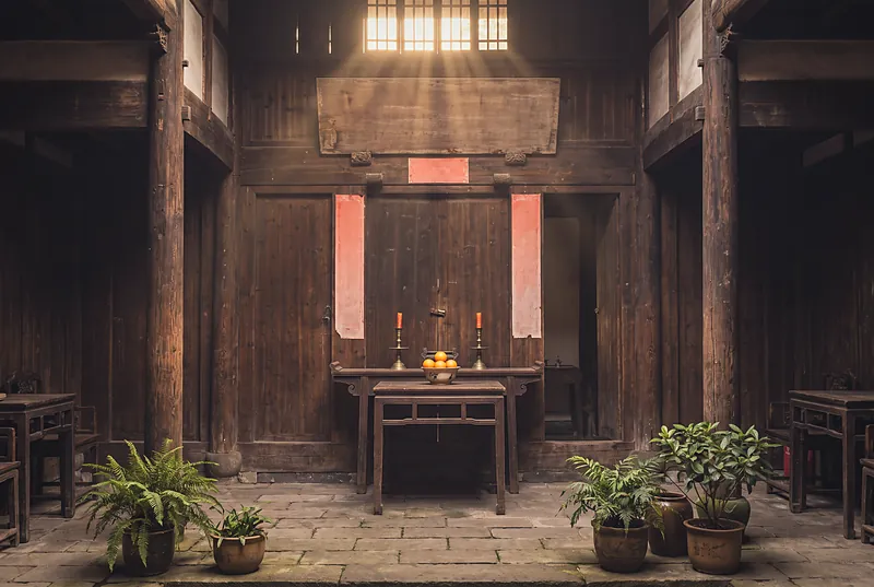 An old wooden family hall in a Sichuan courtyard house with a carved plaque and red couplets in warm light