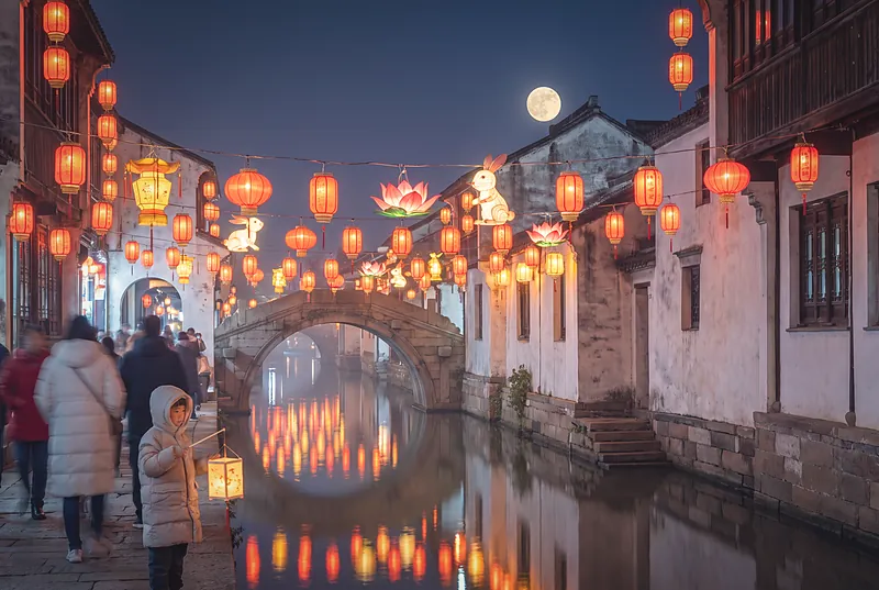 A night lantern fair in an old Chinese riverside town, hung with hundreds of red and gold lanterns above softly blurred crowds